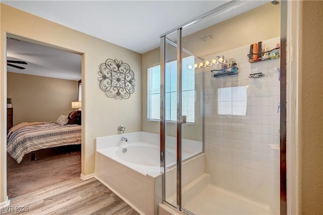 6322 Highledge St, North Las Vegas, NV 89081 - ensuite bathroom featuring a stall shower, a bath, and wood finished floors