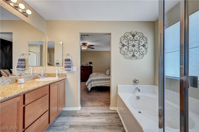 6322 Highledge St, North Las Vegas, NV 89081 - bathroom featuring ensuite bath, vanity, wood finished floors, a ceiling fan, and a bath