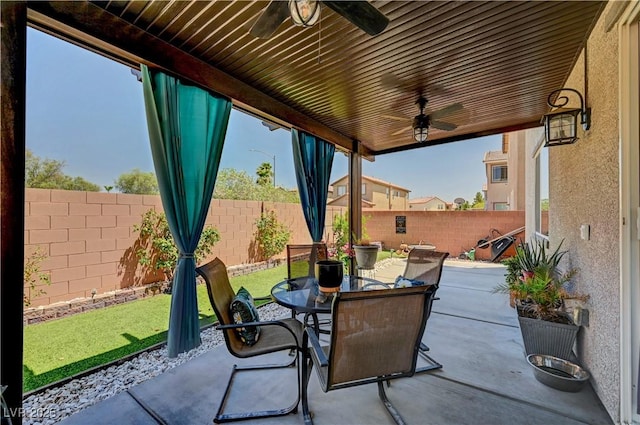 6322 Highledge St, North Las Vegas, NV 89081 - fenced backyard with ceiling fan, outdoor dining area, and a patio