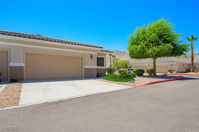 3251 Pheasant Hills Way, Laughlin, NV 89029 - view of front facade with driveway, stucco siding, a tile roof, and a garage