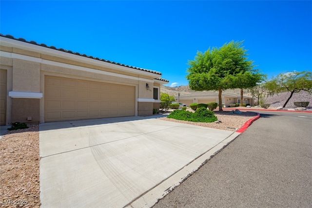 3251 Pheasant Hills Way, Laughlin, NV 89029 - view of front of property with stucco siding, driveway, and an attached garage