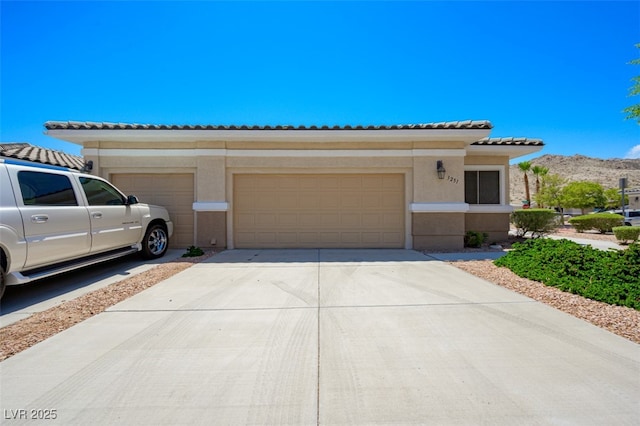 3251 Pheasant Hills Way, Laughlin, NV 89029 - view of front facade with a garage, driveway, stucco siding, and a tiled roof