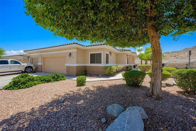 3251 Pheasant Hills Way, Laughlin, NV 89029 - view of front of property with a tiled roof, stucco siding, a garage, and driveway