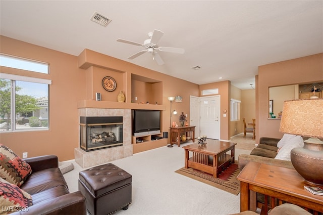 3251 Pheasant Hills Way, Laughlin, NV 89029 - carpeted living area with a tiled fireplace and ceiling fan