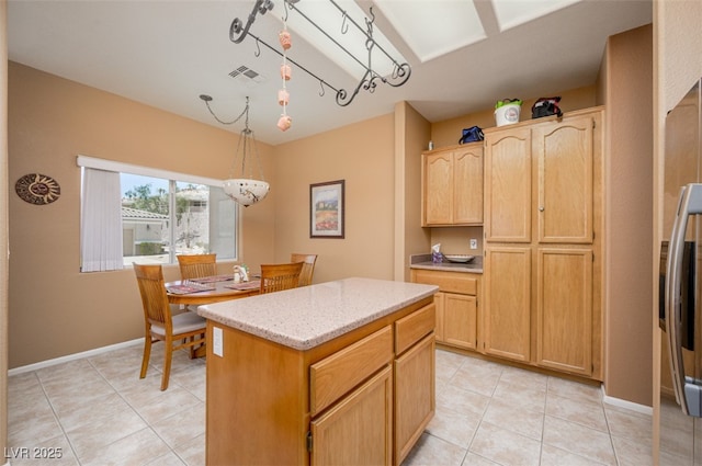 3251 Pheasant Hills Way, Laughlin, NV 89029 - kitchen featuring light brown cabinets, light tile patterned floors, a kitchen island, and pendant lighting