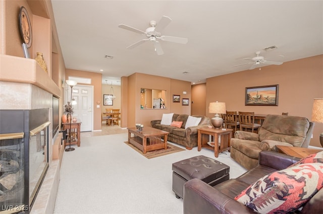 3251 Pheasant Hills Way, Laughlin, NV 89029 - living area featuring a ceiling fan, light carpet, and a tile fireplace