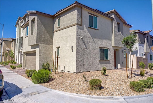 6831 Crimson Shadow St, North Las Vegas, NV 89086 - view of home's exterior featuring a garage, stucco siding, and a residential view