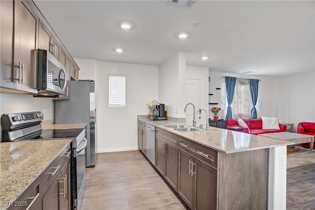 6831 Crimson Shadow St, North Las Vegas, NV 89086 - kitchen featuring appliances with stainless steel finishes, a peninsula, plenty of natural light, light wood-type flooring, and recessed lighting