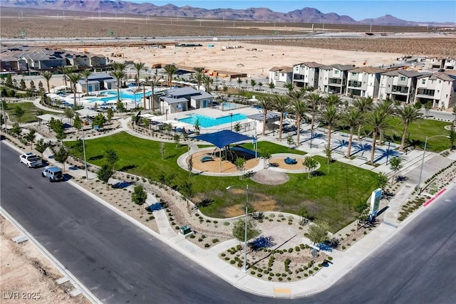 6831 Crimson Shadow St, North Las Vegas, NV 89086 - drone / aerial view of a pool and a mountainous background
