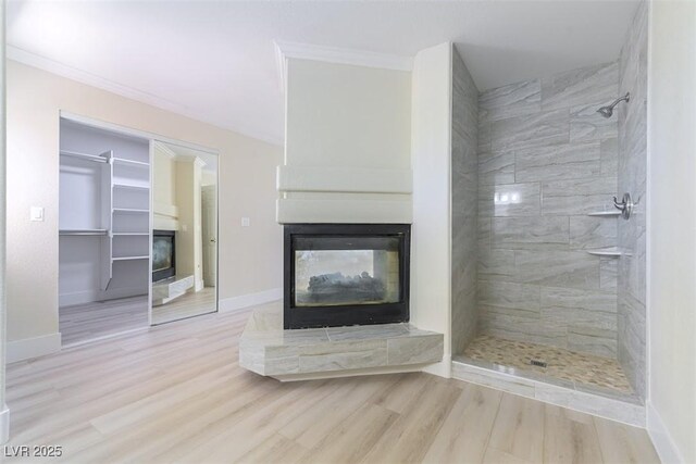 1846 Autumn Gold Ave, Las Vegas, NV 89123 - unfurnished living room featuring a multi sided fireplace, wood finished floors, and ornamental molding
