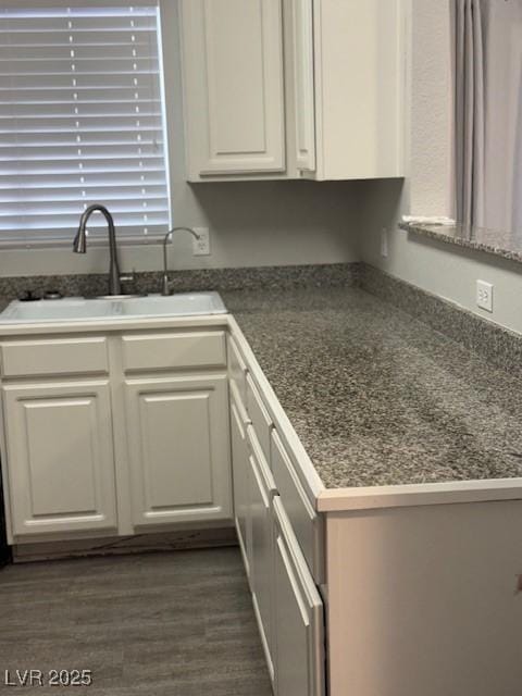 5250 S Rainbow Blvd Unit 1155, Las Vegas, NV 89118 - kitchen featuring white cabinetry, dark countertops, and dark wood-type flooring