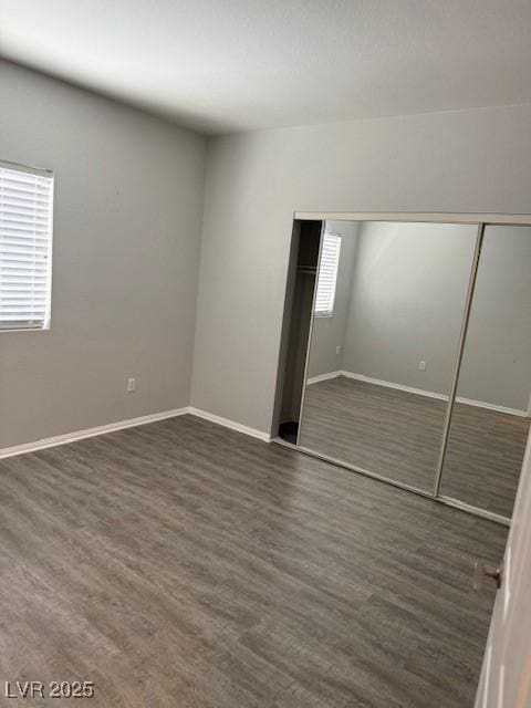 5250 S Rainbow Blvd Unit 1155, Las Vegas, NV 89118 - unfurnished bedroom featuring a closet and dark wood finished floors