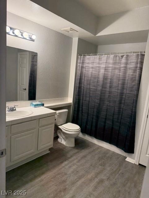 5250 S Rainbow Blvd Unit 1155, Las Vegas, NV 89118 - bathroom with wood finished floors, vanity, a textured wall, and curtained shower