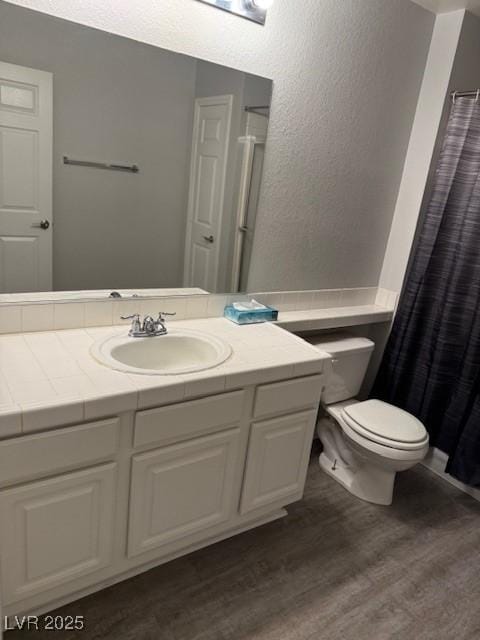 5250 S Rainbow Blvd Unit 1155, Las Vegas, NV 89118 - bathroom with wood finished floors, vanity, a textured wall, and a shower with shower curtain