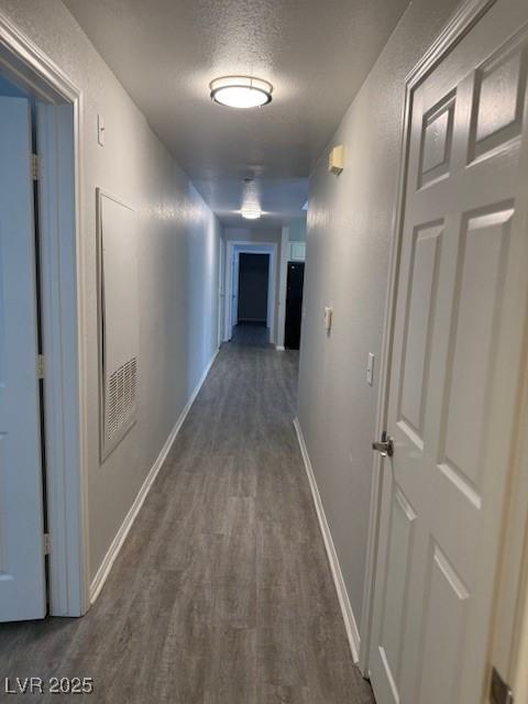 5250 S Rainbow Blvd Unit 1155, Las Vegas, NV 89118 - hallway with dark wood-type flooring and a textured ceiling