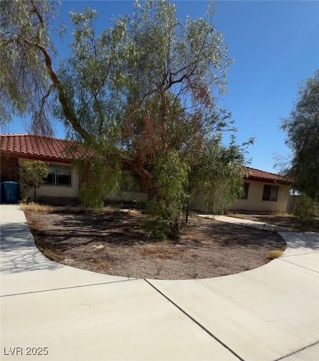 2969 E Quail Ave, Las Vegas, NV 89120 - view of front of property with a tiled roof, stucco siding, and concrete driveway
