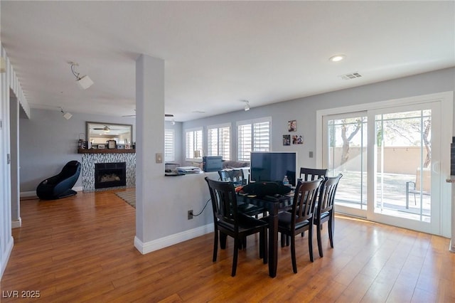 212 Stour Ln, Las Vegas, NV 89144 - dining space featuring a fireplace, wood finished floors, a ceiling fan, and recessed lighting