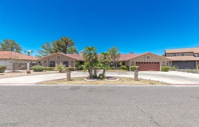 3430 Tanto Cir, Las Vegas, NV 89121 - view of front of house with driveway, an attached garage, and a tile roof