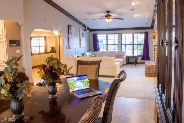 3430 Tanto Cir, Las Vegas, NV 89121 - dining space with ornamental molding, a ceiling fan, light carpet, arched walkways, and light tile patterned floors