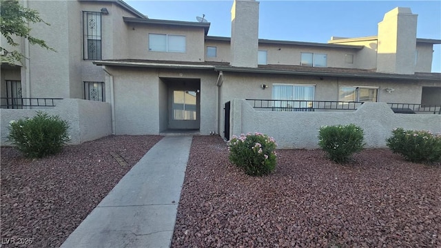 2941 Country Manor Ln Unit 27, Las Vegas, NV 89115 - view of front facade with stucco siding and a chimney