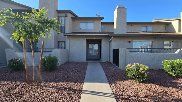 2941 Country Manor Ln Unit 27, Las Vegas, NV 89115 - view of front of home featuring a chimney and stucco siding