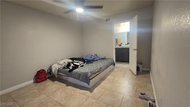 2941 Country Manor Ln Unit 27, Las Vegas, NV 89115 - bedroom featuring light tile patterned floors, ensuite bath, and a ceiling fan
