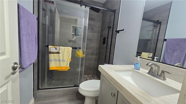 2941 Country Manor Ln Unit 27, Las Vegas, NV 89115 - bathroom with vanity, a stall shower, and wood finished floors