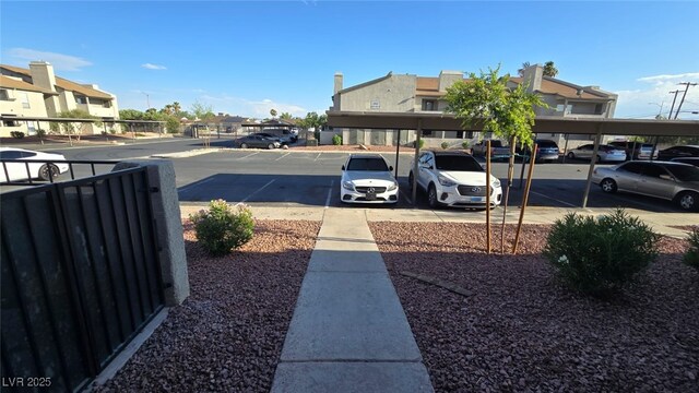 2941 Country Manor Ln Unit 27, Las Vegas, NV 89115 - partially covered parking lot featuring a residential view