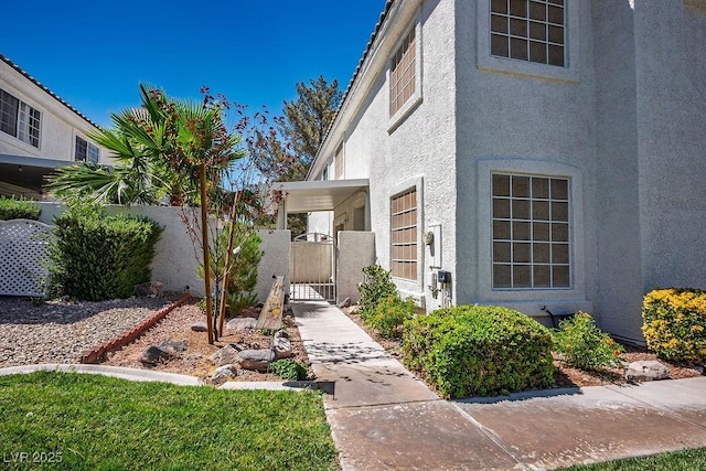2902 Aztec Lily Ln, Henderson, NV 89074 - doorway to property featuring stucco siding and a gate
