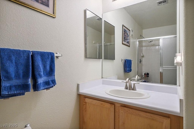 2902 Aztec Lily Ln, Henderson, NV 89074 - full bath with vanity, a shower with door, and a textured wall