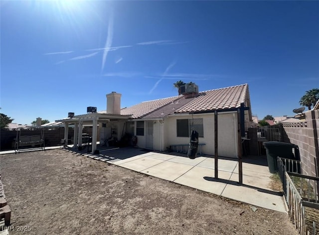 2124 Cabrini Ct, North Las Vegas, NV 89032 - back of property with a pergola, a tile roof, a patio, a fenced backyard, and stucco siding
