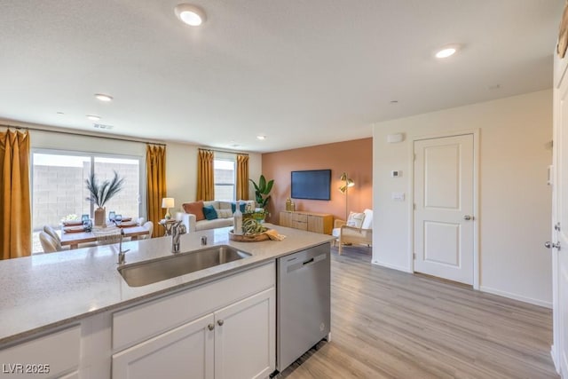 10988 Rollingford Ave Lot 10, Las Vegas, NV 89166 - kitchen with dishwasher, open floor plan, white cabinets, light wood-style flooring, and light stone counters