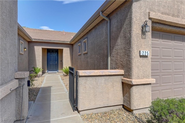 225 Palmetto Pointe Dr, Henderson, NV 89012 - view of exterior entry with stucco siding and a garage