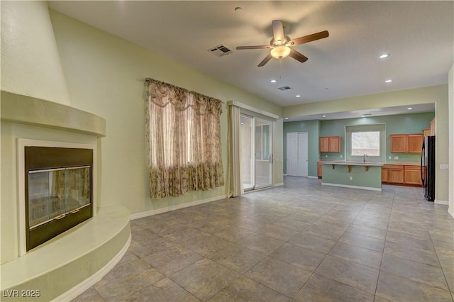 225 Palmetto Pointe Dr, Henderson, NV 89012 - unfurnished living room featuring a ceiling fan, a large fireplace, and recessed lighting