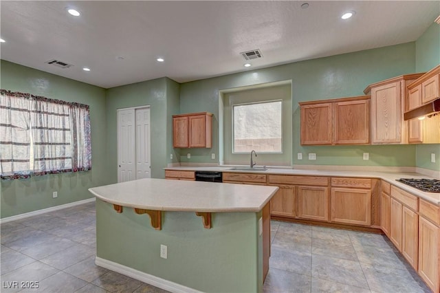 225 Palmetto Pointe Dr, Henderson, NV 89012 - kitchen featuring healthy amount of natural light, light countertops, recessed lighting, a kitchen island, and a breakfast bar