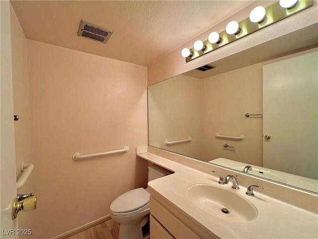 304 Broxton Ln, Las Vegas, NV 89107 - bathroom featuring vanity, wood finished floors, and a textured ceiling