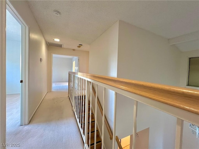 304 Broxton Ln, Las Vegas, NV 89107 - hallway featuring light colored carpet, a textured ceiling, and an upstairs landing