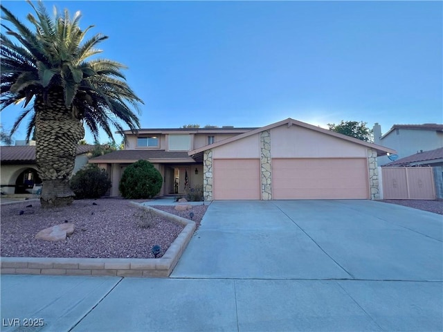 304 Broxton Ln, Las Vegas, NV 89107 - view of front of property featuring stone siding, a garage, and concrete driveway