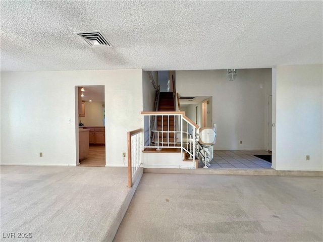 304 Broxton Ln, Las Vegas, NV 89107 - empty room featuring a textured ceiling, carpet floors, and stairway