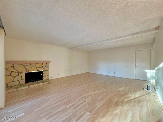 304 Broxton Ln, Las Vegas, NV 89107 - unfurnished living room featuring a textured ceiling, wood finished floors, and a fireplace