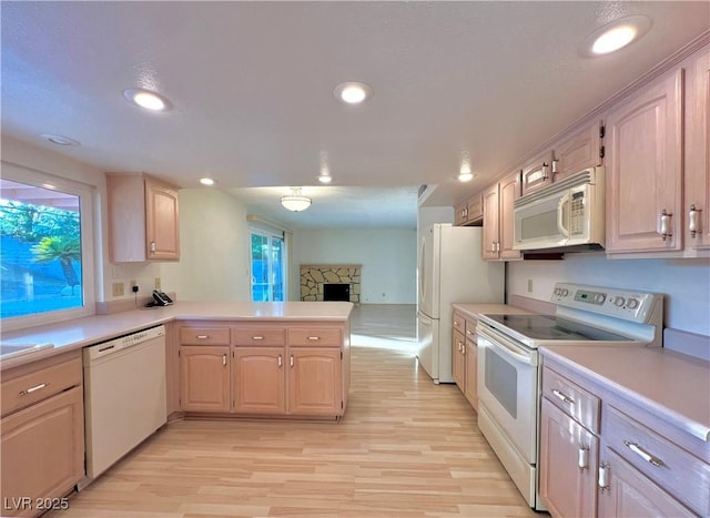 304 Broxton Ln, Las Vegas, NV 89107 - kitchen featuring white appliances, a peninsula, light countertops, light wood-type flooring, and recessed lighting