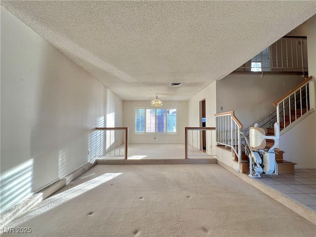 304 Broxton Ln, Las Vegas, NV 89107 - unfurnished living room with a textured ceiling, carpet, a chandelier, and stairs
