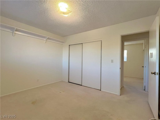 304 Broxton Ln, Las Vegas, NV 89107 - unfurnished bedroom with light carpet, a closet, and a textured ceiling