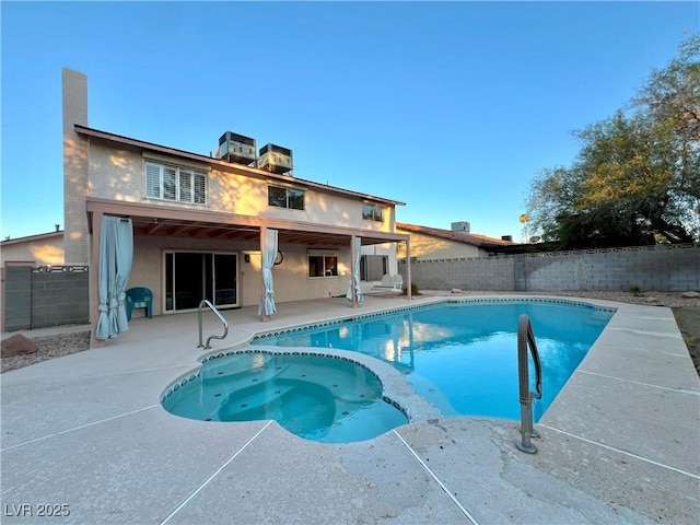 304 Broxton Ln, Las Vegas, NV 89107 - rear view of property with a patio, a fenced backyard, stucco siding, and a pool with connected hot tub