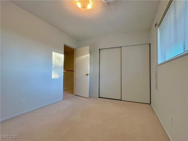 304 Broxton Ln, Las Vegas, NV 89107 - unfurnished bedroom featuring light carpet, a closet, and a textured ceiling