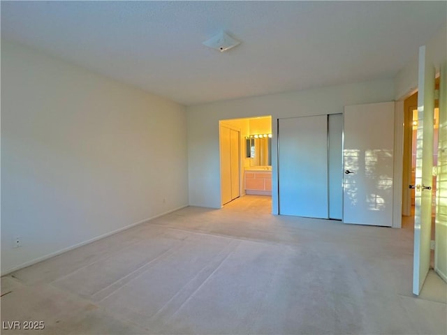 304 Broxton Ln, Las Vegas, NV 89107 - unfurnished bedroom with light carpet, a closet, and connected bathroom