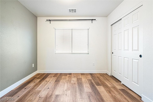 9432 Logan Ridge Ct, Las Vegas, NV 89139 - unfurnished bedroom featuring wood finished floors and a closet