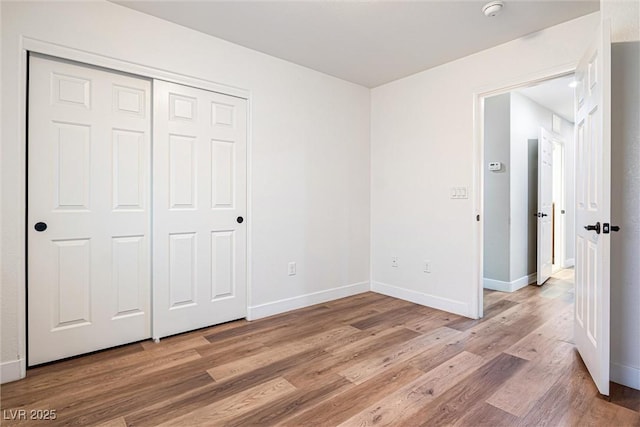 9432 Logan Ridge Ct, Las Vegas, NV 89139 - unfurnished bedroom with light wood-type flooring and a closet