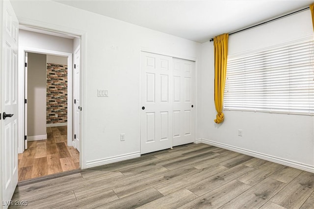 9432 Logan Ridge Ct, Las Vegas, NV 89139 - unfurnished bedroom featuring wood finished floors and a closet