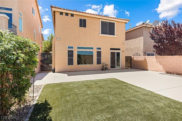9432 Logan Ridge Ct, Las Vegas, NV 89139 - rear view of house featuring stucco siding, a gate, and a patio area